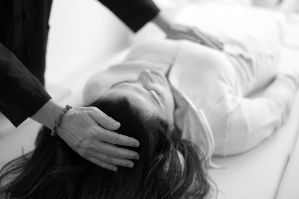 therapist man doing holistic therapy reiki to a woman. energy tr